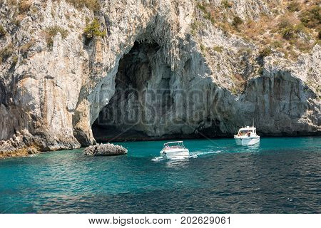 CAPRI ITALY - JUNE 13 2017: Boats with tourists near Grotta Bianca and Grotta Meravigliosa Capri Italy