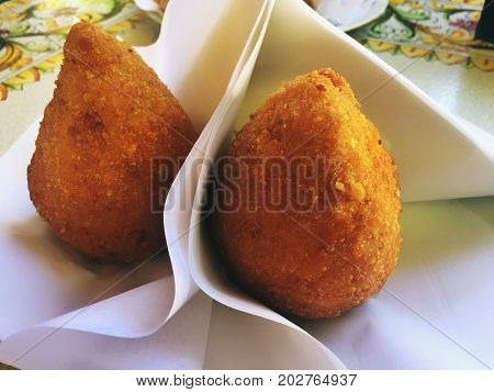 Typical Sicilian Arancino: a fried ball made with rice and meat (ragù sauce)