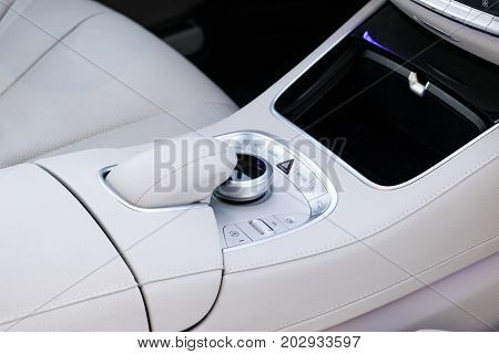 Media and navigation control buttons of a Modern car. Car interior details. White leather interior of the luxury modern car. Modern car interior