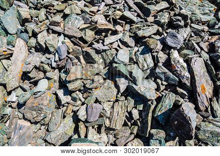 Natural Texture Of Mountain Of Friable Boulders Close Up. Detailed Background Of Gray Stones With Or