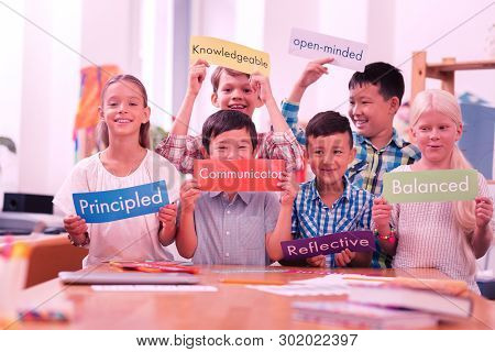 Children Of Different Races Holding Colorful Adjectives.