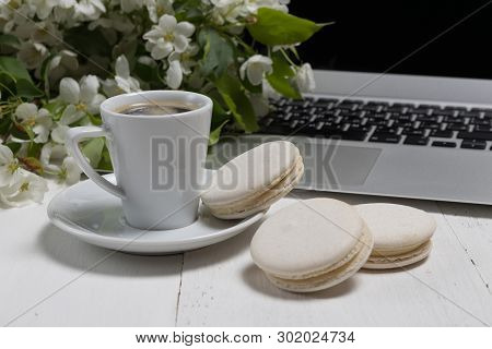 Little Delicate Elegant Bouquet Of Spring Flowers And A Teacup On White Wooden Table, Morning Breakf