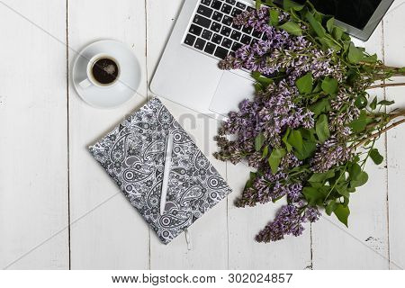 Little Delicate Elegant Bouquet Of Spring Flowers And A Teacup On White Wooden Table, Morning Breakf