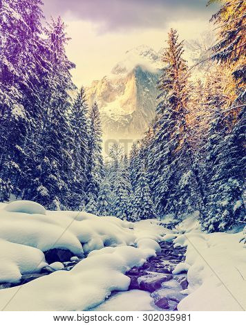 Winter Wonderland In The Austrian Alps. Majestic Alpine Mountain On The Background. Dramatic Scene. 