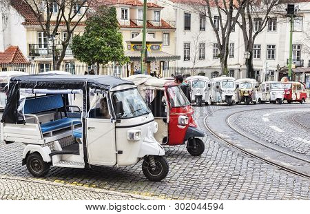 1 March 2018: Lisbon, Portugal - Covered Tuk Tuks Ready For Hire Outside Lisbon Cathedral.