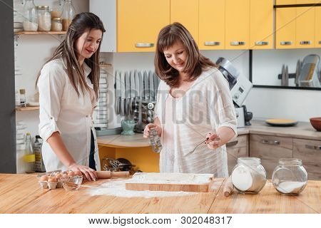 Home Culinary Class. Family Cooking In Kitchen. Daughter Learning Methods Of Making Biscuits. Mother