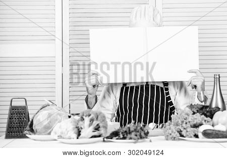 Man Chef In Hat And Apron Read Book. Culinary Recipes Book Concept. Improve Cooking Skill. Useful Bo