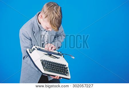 Using A Typing Machine. Small Kid Typewriting On Old Typewriter. Smart Schoolboy With Vintage Typewr