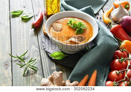Spicy Vegetable Soup With Baked Bell Peppers, Tomatoes, Carrots, Chili, Red Onion, Garlic And Ginger