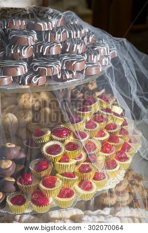 Wedding Day Cookie Table Covered By Veil With Buckeyes And Cheesecake Bites Among Other Baked Goods