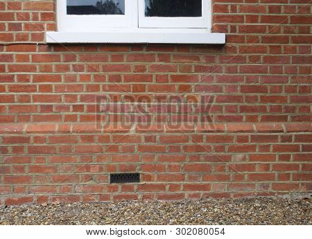 Brick Wall Of House With Part Of Window Showing And Air Brick - Ideal Background Image