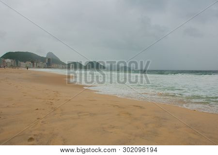 Rio De Janeiro: The Most Famous Beach, Copacabana Beach In Cloudy Weather. Brazil