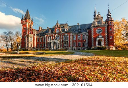 Awesome Sunny Landscape, Perfect Sky Over The Fairytale Castle With Fall Autumn Leafes On Foreground