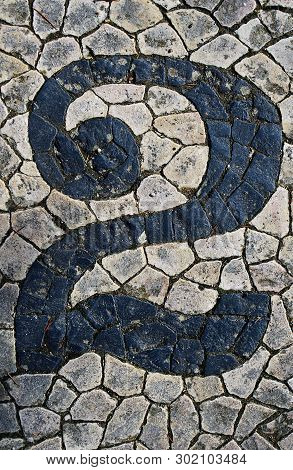 Portuguese Sidewalk Of Calcada In The Form Of The Number 2. Lisbon, Portugal