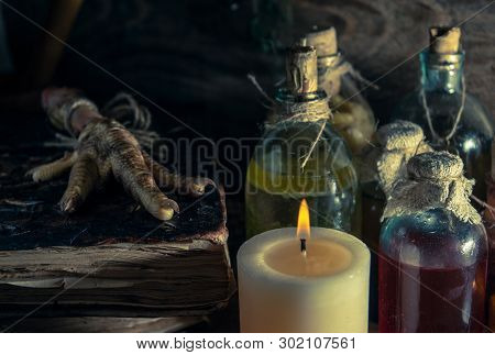 A Witchery Stuff: Multiple Tincture Bottles, Bunches Of Dry Healthy Herbs, Stack Of Ancient Ritual T