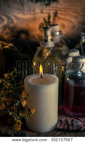A Witchery Stuff: Multiple Tincture Bottles, Bunches Of Dry Healthy Herbs, Stack Of Ancient Ritual T