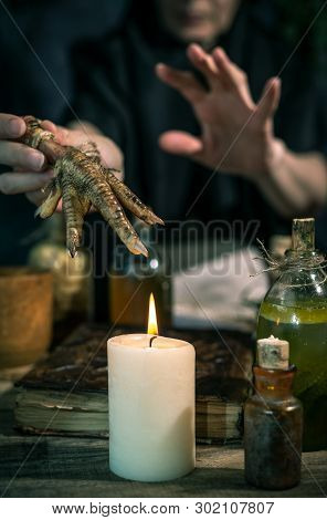 Dark Witch At Work: Black Magic Woman Makes The Witchery By Mixing Herbs, Casting The Spells, Runnin