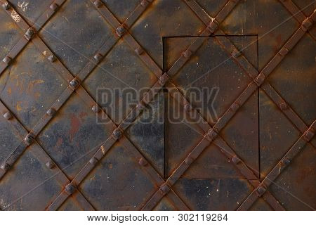 Fragment Of Old Metal Gate With Rivets And A Viewing Window At The St. Nicholas Gate Tower Of The Za