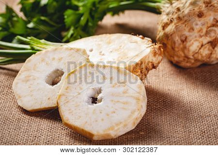 Celery Root With Leaves On Sackcloth Background. Close Up