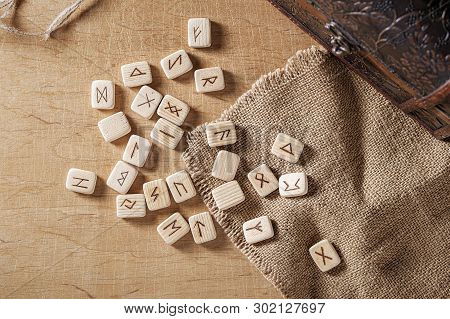 Handmade Scandinavian Wooden Runes On A Wooden Vintage Background. Concept Of Fortune Telling And Pr
