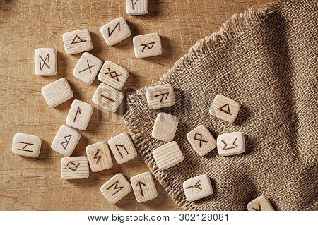 Handmade Scandinavian Wooden Runes On A Wooden Vintage Background. Concept Of Fortune Telling And Pr