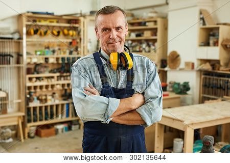 Waist Up Portrait Of Confident Senior Carpenter Looking At Camera While Working In Joinery, Copy Spa
