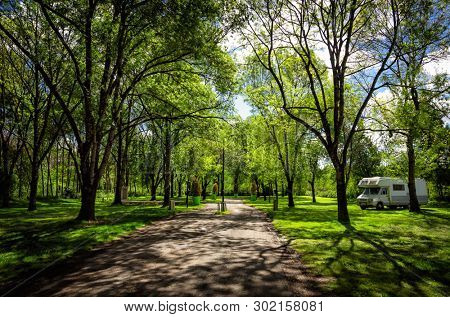 Campsite in the forest with a campervan, pacefull and tranquil scene, relax and freedom concept