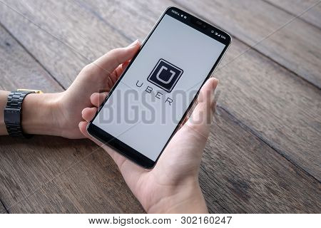 Chiang Mai,thailand - May 11, 2019 : Man Holding Uber App Showing On Oneplus 6 In The Car,uber Is Sm