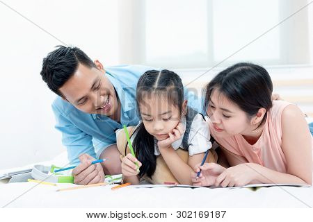Asian People, Happy Family In Bedroom At Home. Mother, Father And The Children Playing, Activities O
