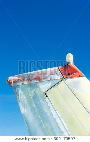 Tail Fin, Rudder And Beacon Lights, Small Single Engine Airplane With Old Paint And Bright Blue Sky.
