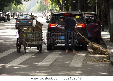 Chinese Woman Road Sweeper Working Clean And Keep Garbage And Push Garbage Cart On The Road And Peop