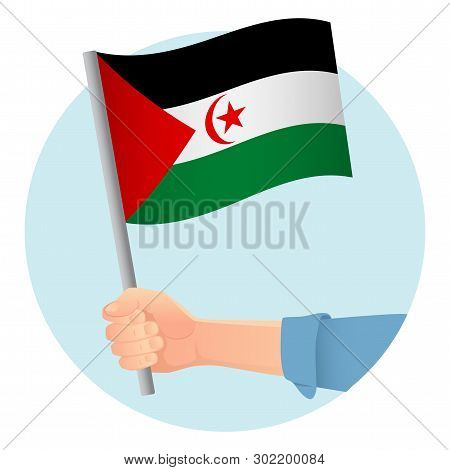 Sahrawi Arab Democratic Republic Flag In Hand. Patriotic Background. National Flag Of Sahrawi Arab D