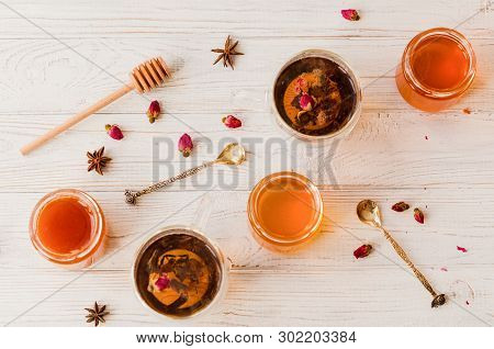 Composition With Honey, Tea And Tea Accessories On A White Wooden Background.