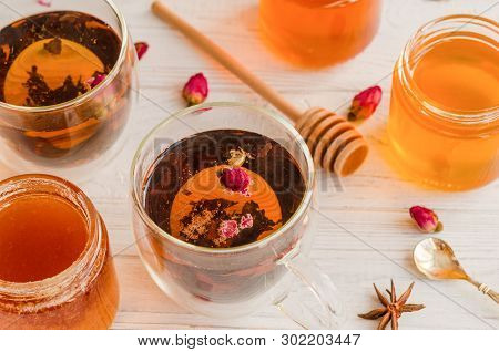 Composition With Honey, Tea And Tea Accessories On A White Wooden Background.