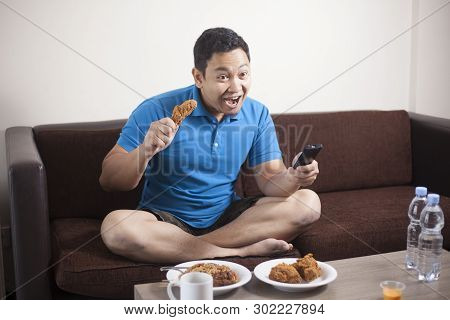 Asian Man Watching Soccer On Tv