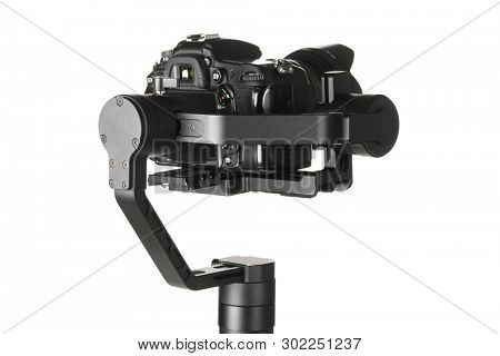 Gimbal three-axis motorized stabilizer with mounted DSLR camera isolated on white background
