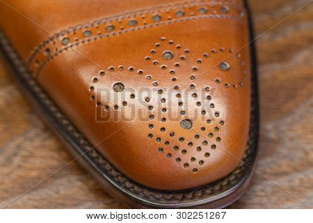 brown brogue toe of men full grain leather shoe, close up