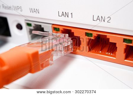 Red Patch Cord Utp 5e Cable Inserted Into Red Free Port, Home Router