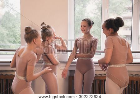 Young Graceful Female Ballet Dancers Dancing At Training Studio. Beauty Of Classic Ballet. Girls Res
