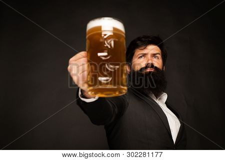 Handsome Bearded Man Drinking Beer. Portrait Of Handsome Young Man Tasting A Draft Beer. Man Holding