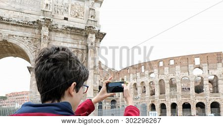Boy Photographs Colosseum In Rome With A Mobile Phone