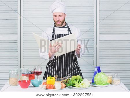 Man Bearded Chef Cooking Food. Guy Read Book Recipes. Culinary Arts Concept. Man Learn Recipe. Impro