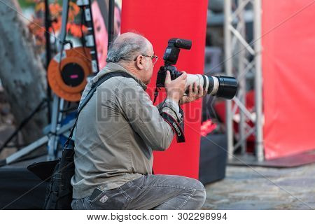 Caceres, Extremadura, Spain - May 20, 2019: Professional Photographer Taking Photographs During The 