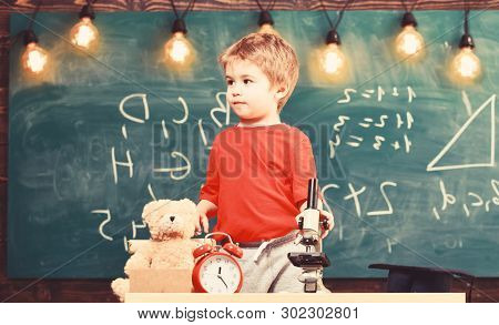 Child, Pupil On Calm Face Near Microscope. First Former Interested In Studying, Learning, Education.