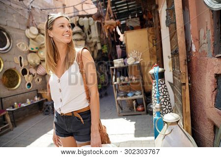 Tourist girl shopping in Moroccan souk of Marrakech