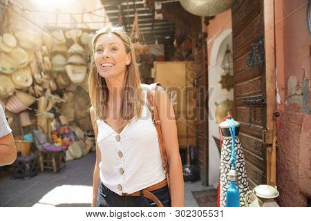 Tourist girl shopping in Moroccan souk of Marrakech