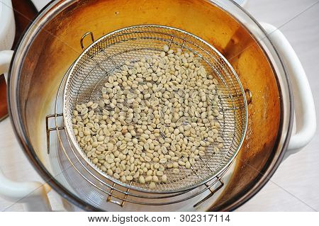 Homemade Roast Of Green Coffee Beans In Aerogrill. Top View