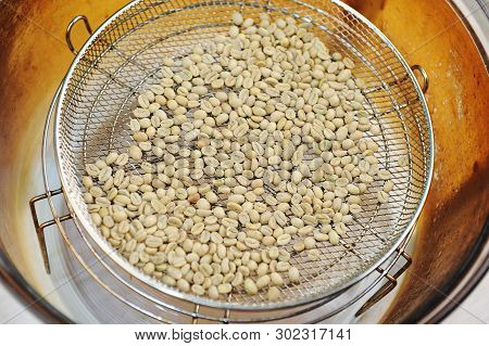 Homemade Roast Of Green Coffee Beans In Aerogrill. Top View