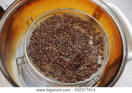 Freshly Roasted Coffee Beans In Aerogrill. Top View. Home Roasting