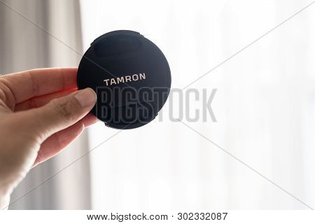 Baltimore, Maryland - May 14, 2019: Hand Holds Up A Tamron Brand Camera Lens Cap For A Dslr Camera. 